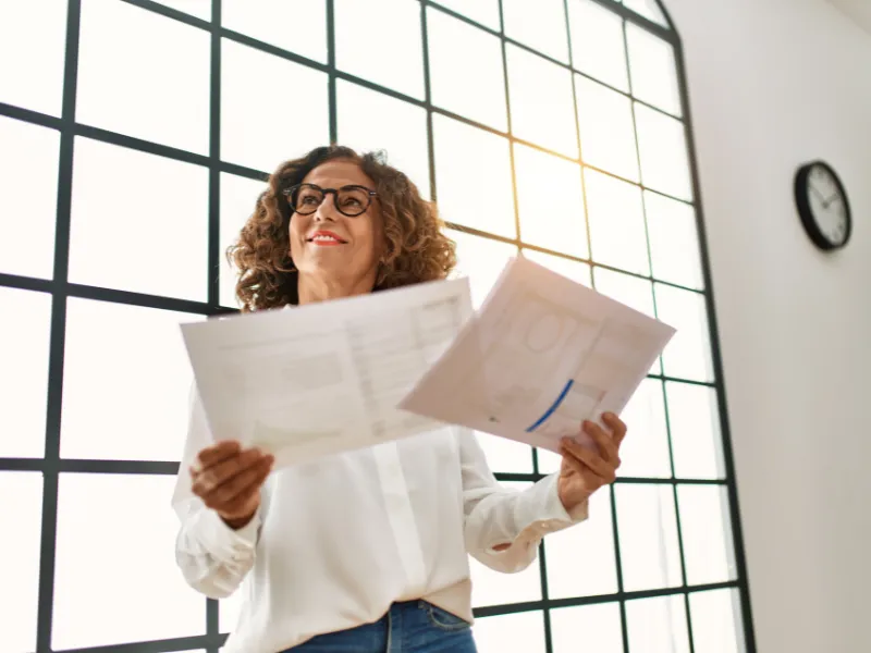 financial advisor woman with workflows and process in hand from business coach
