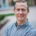 male financial advisor smiling for a photograph